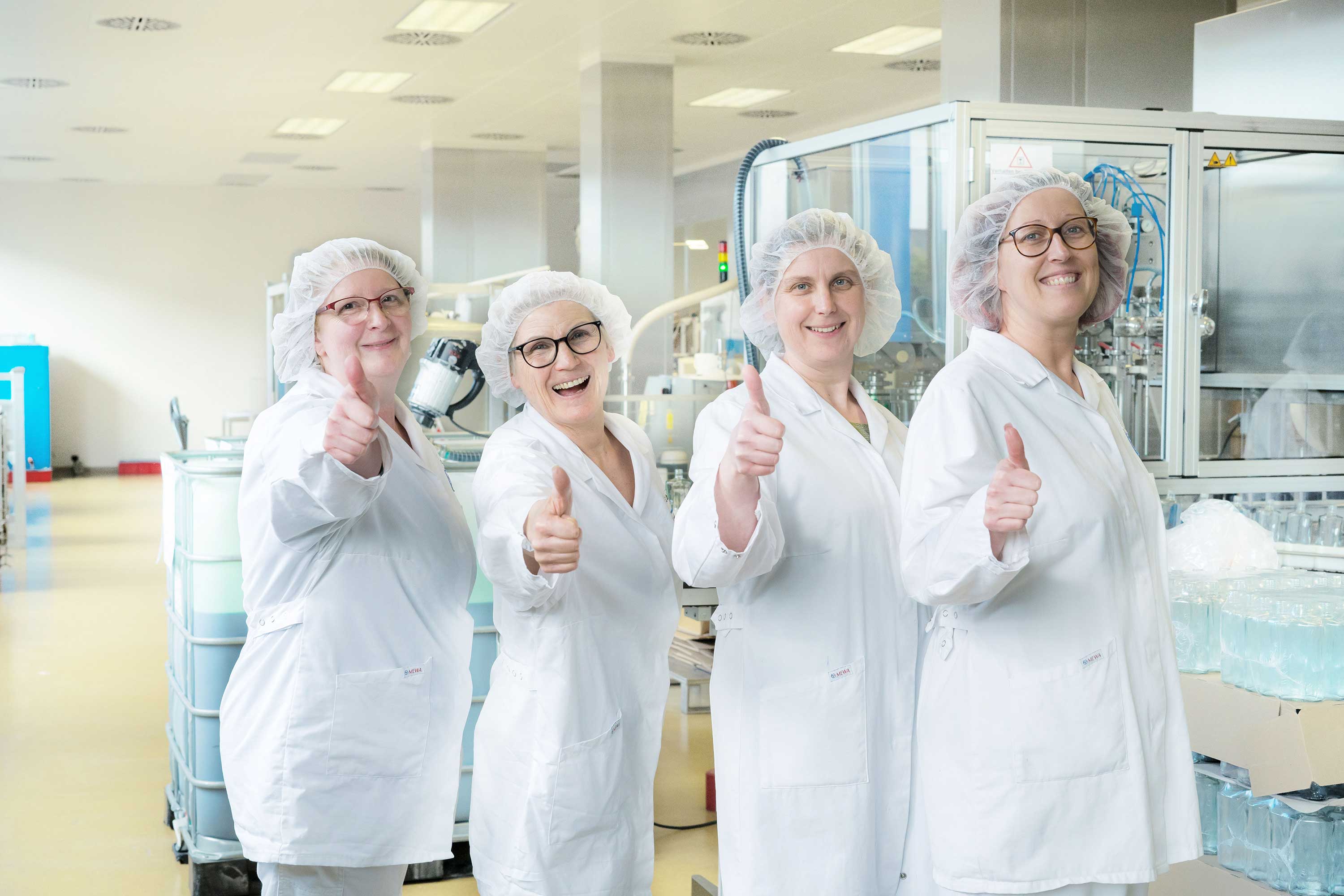 Female employees are laughing and giving a thumbs-up